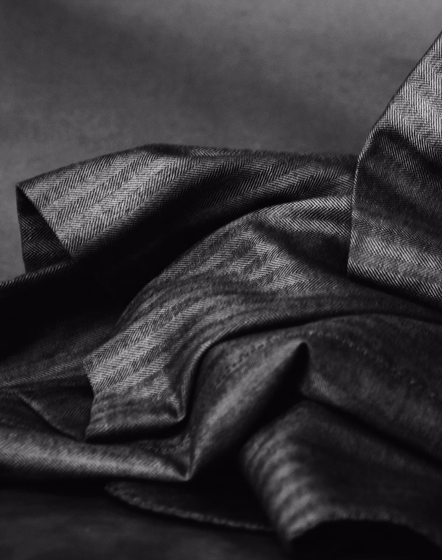 Draped grey herringbone wool fabric