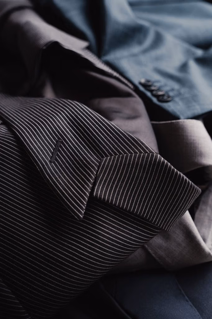 Close-up of pinstripe and grey suit jackets