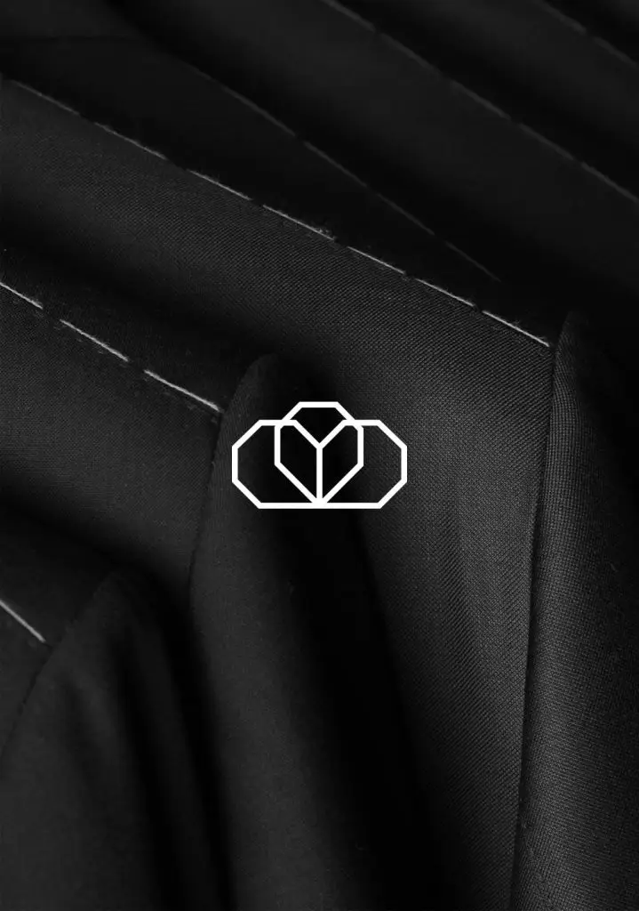 Costume Limité crown emblem stitched on dark tailoring fabric